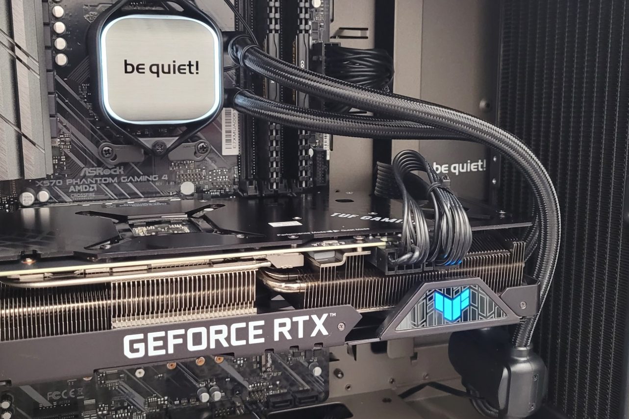 Close-up of a computer's internal components, featuring a GeForce RTX graphics card.